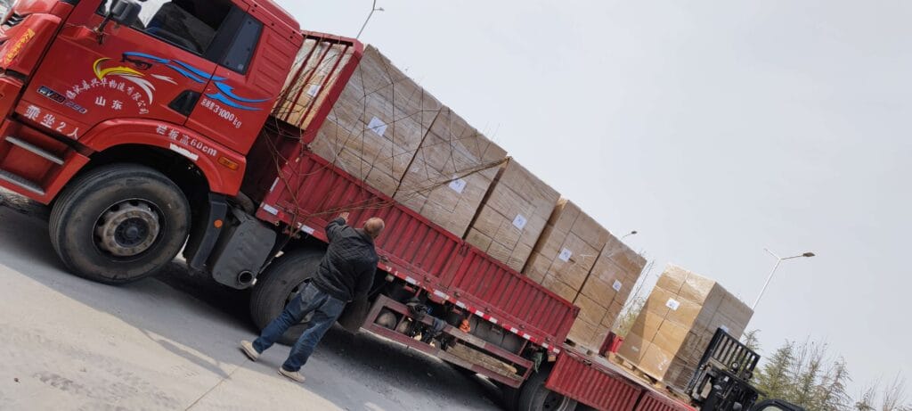 Red truck loaded with aquarium landscape products for global shipping in Year of the Horse
