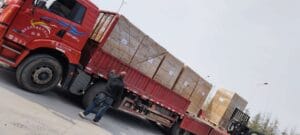 Red truck loaded with aquarium landscape products for global shipping in Year of the Horse