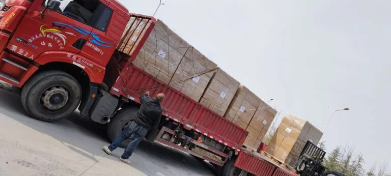 Red truck loaded with aquarium landscape products for global shipping in Year of the Horse